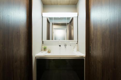 a bathroom with a sink and a mirror at VACATION RENT Kanazawa - Vacation STAY 69538v in Kanazawa