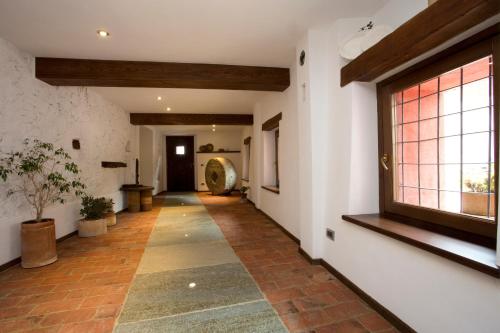 a hallway of a house with a window and a floor at B&B La Ceramica Moline in Vicoforte