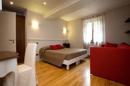 a bedroom with a bed with red pillows on it at B&B La Ceramica Moline in Vicoforte