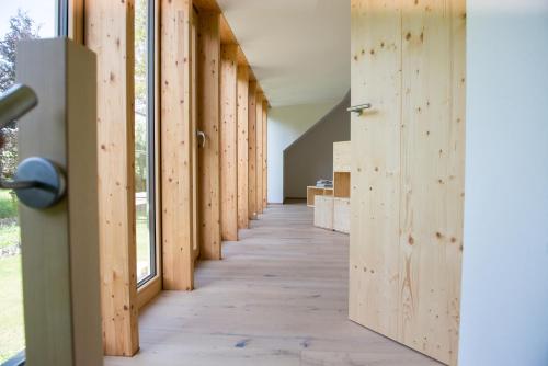 an empty hallway with wooden walls and a door at Haflingerstall in Neudiehman