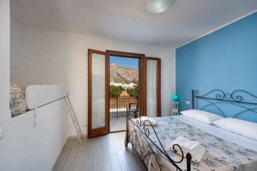 a bedroom with a bed and a view of a mountain at Le case di San Vito in San Vito lo Capo