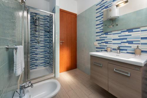 a bathroom with a sink and a shower and a toilet at Le case di San Vito in San Vito lo Capo