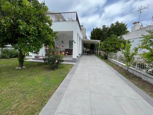 a walkway in front of a white house at Beach Villas in Kemer