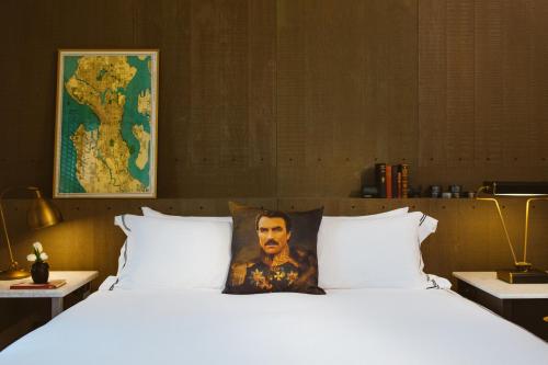 a bed with a picture of a man on the pillow at Kimpton Palladian Hotel, an IHG Hotel in Seattle