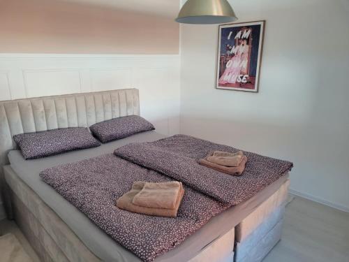 a bed with two towels on top of it at "Loft" in Wolfenbüttel in Wolfenbüttel