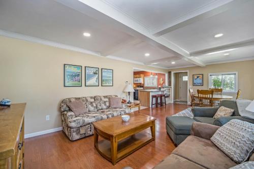 a living room with couches and a table at Pleasant Street Retreat in Boyne City