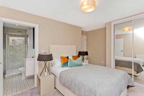 a white bedroom with a bed and a shower at Modern City Centre 2 Bedroom 2 Bathroom Apartments, Main Door Ground with Private Parking in Edinburgh