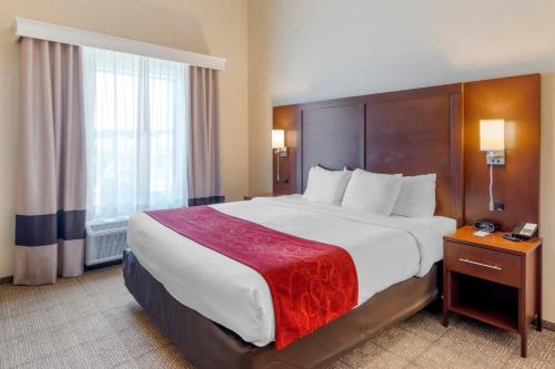 a hotel room with a large bed and a window at Comfort Suites St George - University Area in St. George