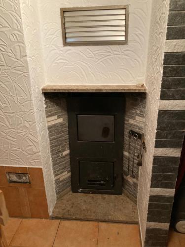 a brick fireplace in a room with a window at Kleines Haus am Waldrand, Haustiere auf Nachfrage in Klughaus