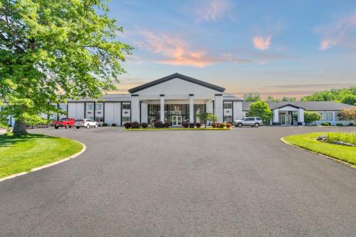 a rendering of a house with a driveway at Days Inn by Wyndham Erie in Erie