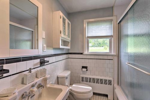 a bathroom with a sink and a toilet and a window at Cozy Middletown Home Near Beaches and Newport! in Middletown