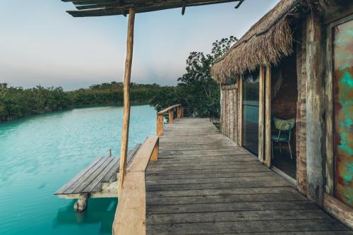 a wooden bridge over a body of water at Embajada Universal By La Eufemia Group in Huay Pix