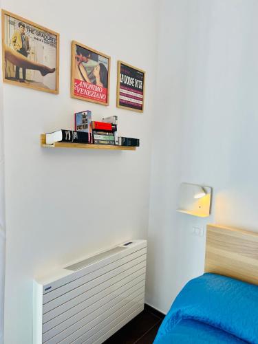 a bedroom with a bed and some pictures on the wall at B&B letterario Palazzo Pistocchi in Teramo