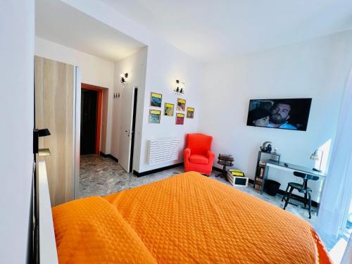 a bedroom with an orange bed and a red chair at B&B letterario Palazzo Pistocchi in Teramo