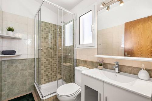 a bathroom with a toilet and a sink and a shower at Villa Gloria in Cala'n Bosch