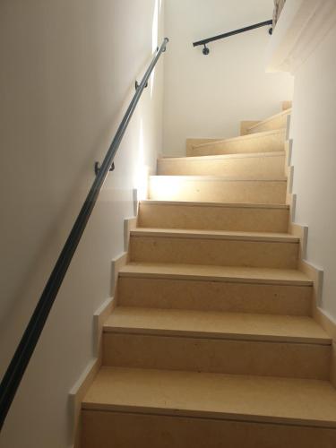 a staircase in a house with wooden steps at Lavender Green Villas in Agios Nikitas