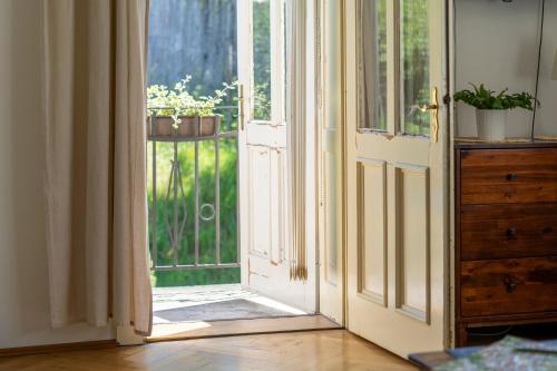 an open door with potted plants on a balcony at Vila Heide in Česká Kamenice