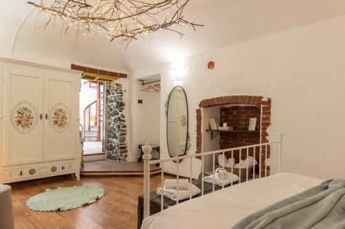 a bedroom with a crib and a mirror at B&B 503 di Alessio e Orsola in Caprie