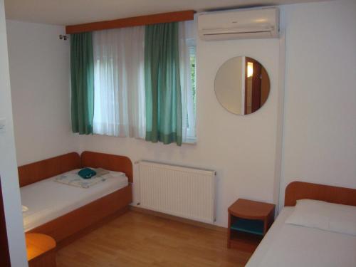 A bed or beds in a room at Guesthouse Koprivec