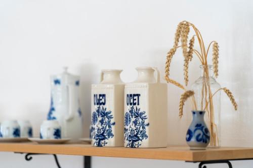 a shelf with blue and white bottles and vases on it at Vila Heide in Česká Kamenice