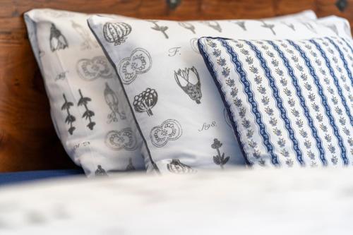 two pillows on a bed with butterflies on them at Vila Heide in Česká Kamenice