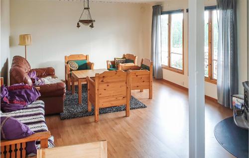 a living room with a couch and a table and chairs at Awesome Home In Trnaby With Wifi in Tärnaby