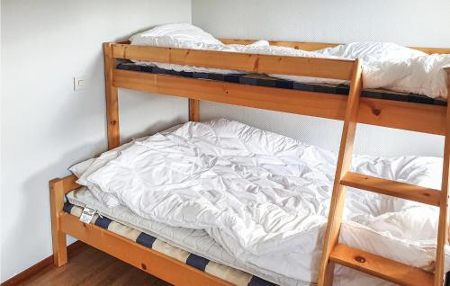 a bedroom with two bunk beds with white sheets at Awesome Home In Trnaby With Wifi in Tärnaby