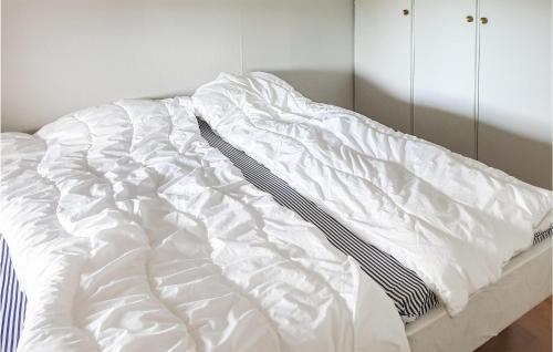 an unmade bed with white sheets in a bedroom at Awesome Home In Trnaby With Wifi in Tärnaby