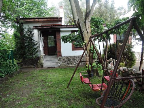 a swing in a yard in front of a house at House in Nowogard by Lake Nowogardzkie in Wyszomierz