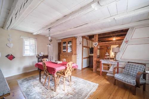 une salle à manger avec une table et des chaises rouges dans l'établissement Chez Jade et Ambre, à Eguisheim