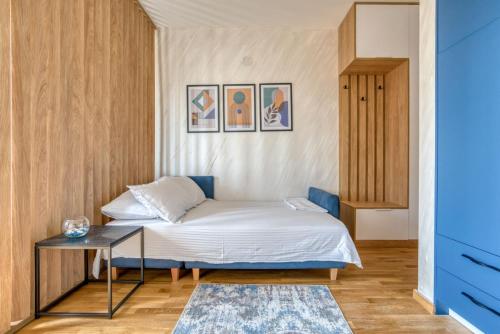 a small bedroom with a bed and a table at Princess Milena Apartments - Studio Balsa in Bečići