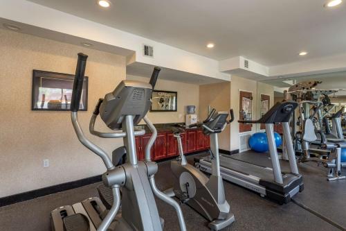 a gym with two treadmills and two exercise bikes at Best Western Plus Boulder Louisville in Louisville
