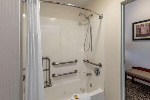 a bathroom with a shower with a shower curtain at Best Western Plus Boulder Louisville in Louisville