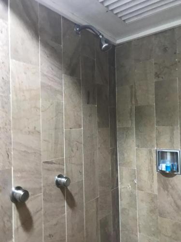 a shower with a glass door in a bathroom at Hotel Aeropuerto in Mexico City