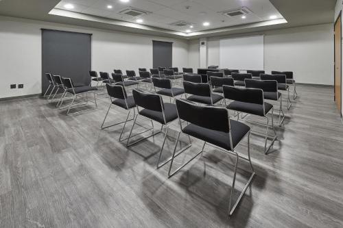a room with rows of chairs in a room at City Express by Marriott Guaymas in Guaymas