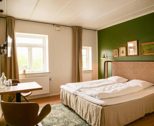 En eller flere senge i et værelse på Hotel Villa Gulle
