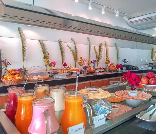 a buffet line with many different types of juice at Paradiso Peró Praia Hotel in Cabo Frio