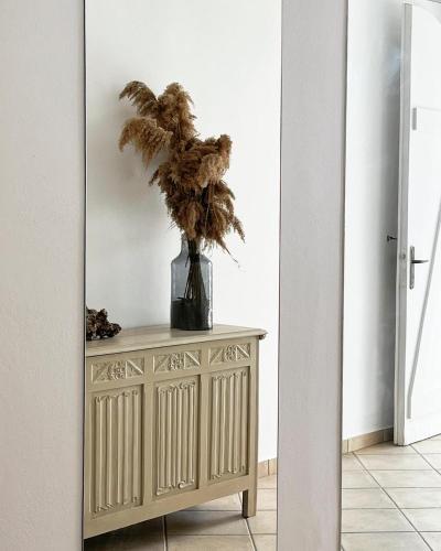 a vase with a plant on a table in a hallway at San Salvatore in Zakynthos Town