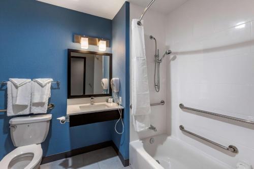 a bathroom with a white toilet and a sink at Best Western Blythe in Blythe
