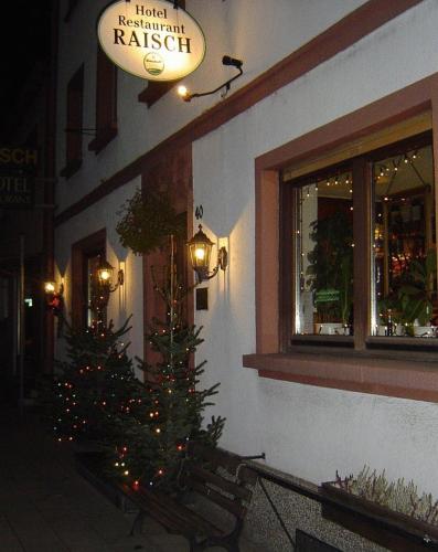 a christmas tree sitting outside of a building at Hotel & Restaurant Raisch in Steinwenden