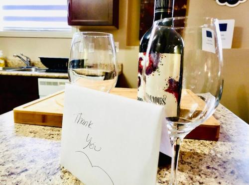 a thank you sign next to a glass of wine at Spacious Basement suite in Camrose