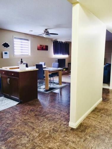 an office with a table and chairs in a room at Spacious Basement suite in Camrose