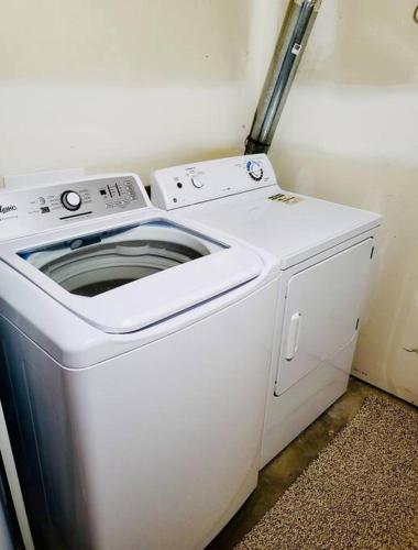 a white washer and dryer in a room at Spacious Basement suite in Camrose