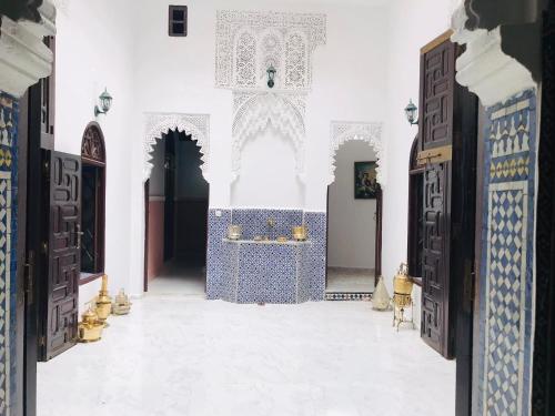 an entrance to a mosque with blue and white walls and doors at Riad Al Ârâr in Rabat