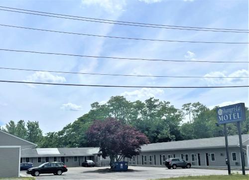a building with a sign for a motel at Shangri-La Motel in Seekonk