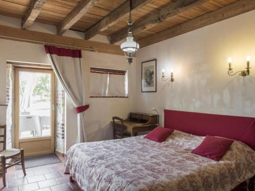 a bedroom with a large bed and a table at Gîte Audes, 6 pièces, 10 personnes - FR-1-489-119 in Audes