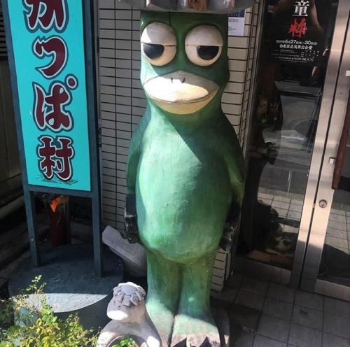 a statue of a frog wearing sunglasses in front of a building at HOTEL TAVINOS ASAKUSA - Vacation STAY 64889 in Tokyo