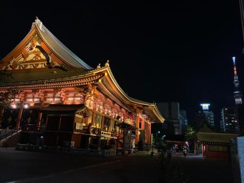 a building with a chinese roof at night at HOTEL TAVINOS ASAKUSA - Vacation STAY 64889 in Tokyo