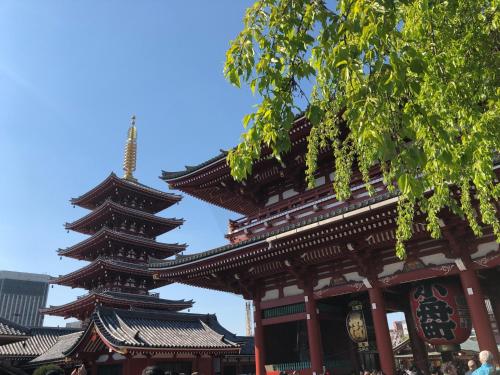a pagoda building with a clock on it at HOTEL TAVINOS ASAKUSA - Vacation STAY 64889 in Tokyo