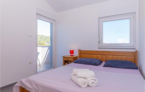 a bedroom with a bed with towels on it at 2 Bedroom Amazing Apartment In Kanica in Zaglavice